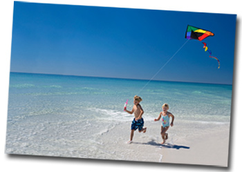 Kids flying a kite on the beach